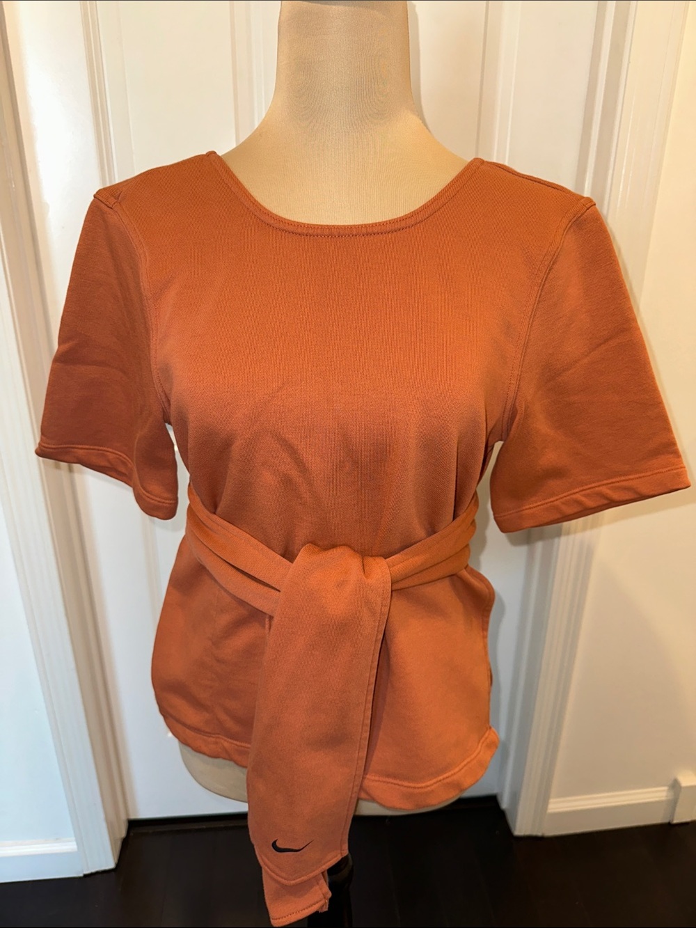 Nike Dri-Fit Short-Sleeve Tie-Waist Top in Rust Orange. Zipper Pocket.Side Slits